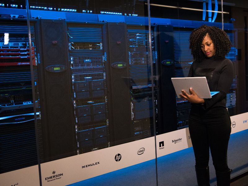 Woman standing and working on analytical data at a cybersecurity company